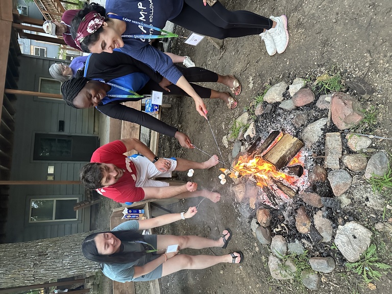 Residents roast marshmallows over a fire at diabetes camp during their endocrinology rotation.