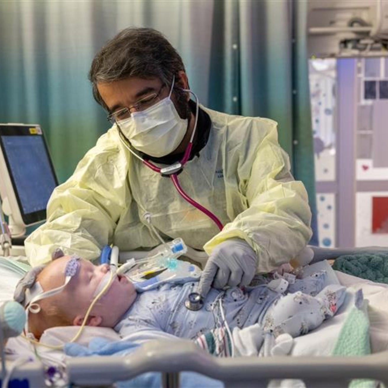 Aditya Badheka tends to a patient in the PICU on Tuesday, Feb. 14, 2023. Patient consent form on file.