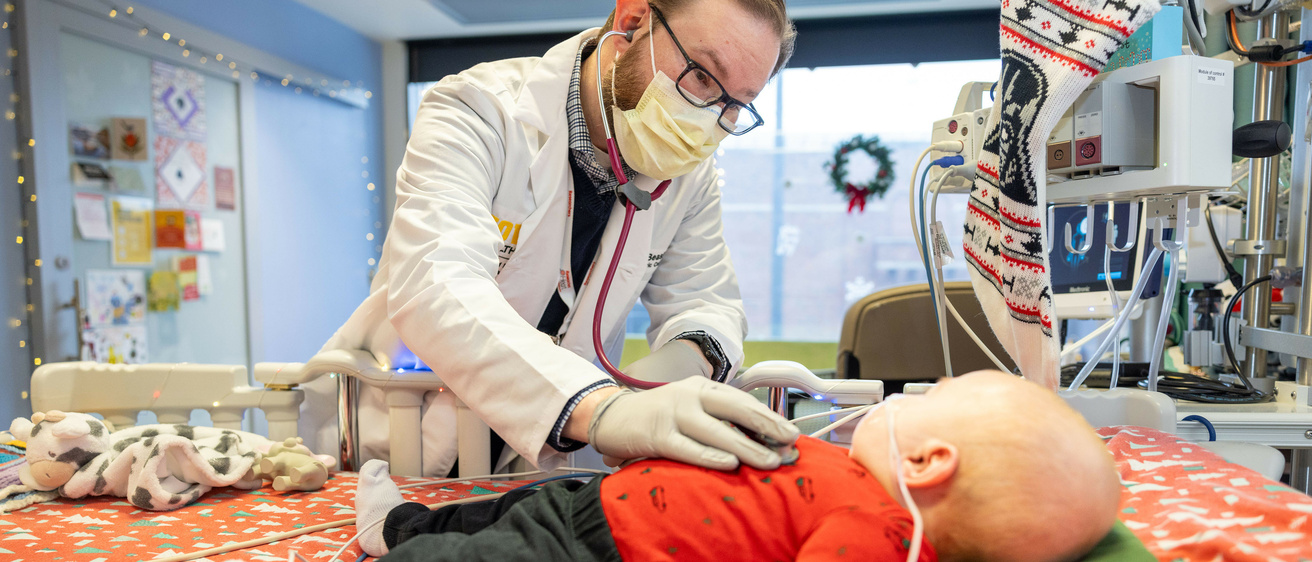 Gary Beasley, Clinical Associate Professor of Pediatrics-Cardiology, examines Baby Wesley.
