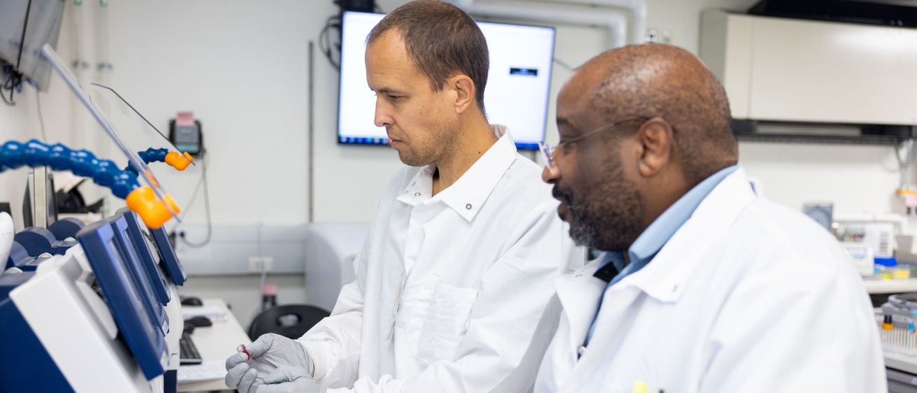 Mike Nordberg (left), medical laboratory scientist, and Dion Baylor, medical laboratory technician, operate a radiometer blood gas analyzer in the critical care laboratory of the pathology labs on the UI Health Care university campus on Wednesday, Oct. 30, 2024.