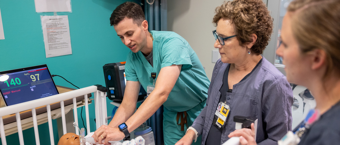 Dr. Daniel Hinds, pediatric pulmonologist, prepares a NICU simulation for parents. 