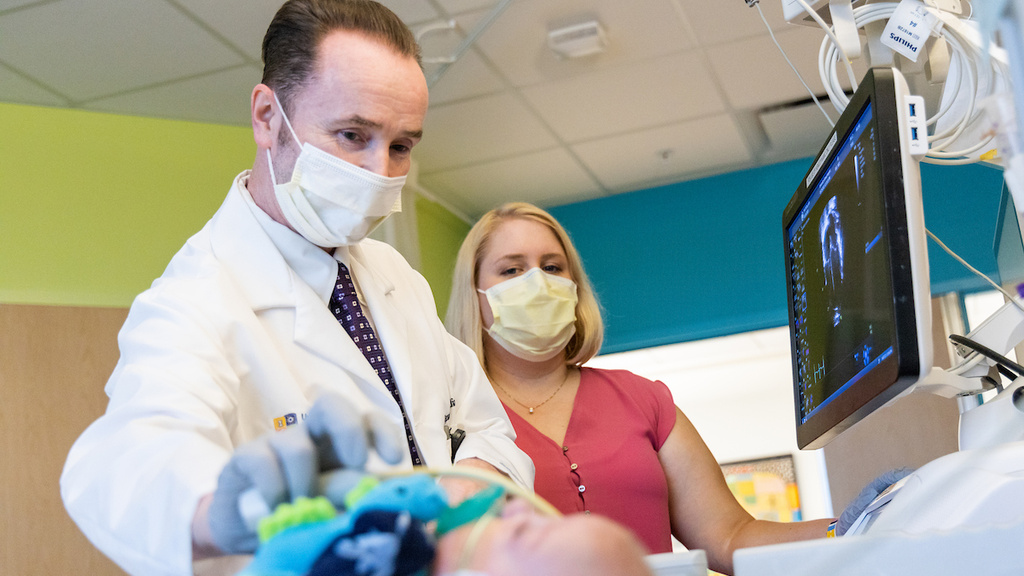 Dr. McNamara examines a NICU patient at UI Stead Family Children's Hospital