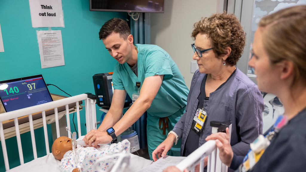Dr. Daniel Hinds, pediatric pulmonologist, prepares a NICU simulation for parents. 