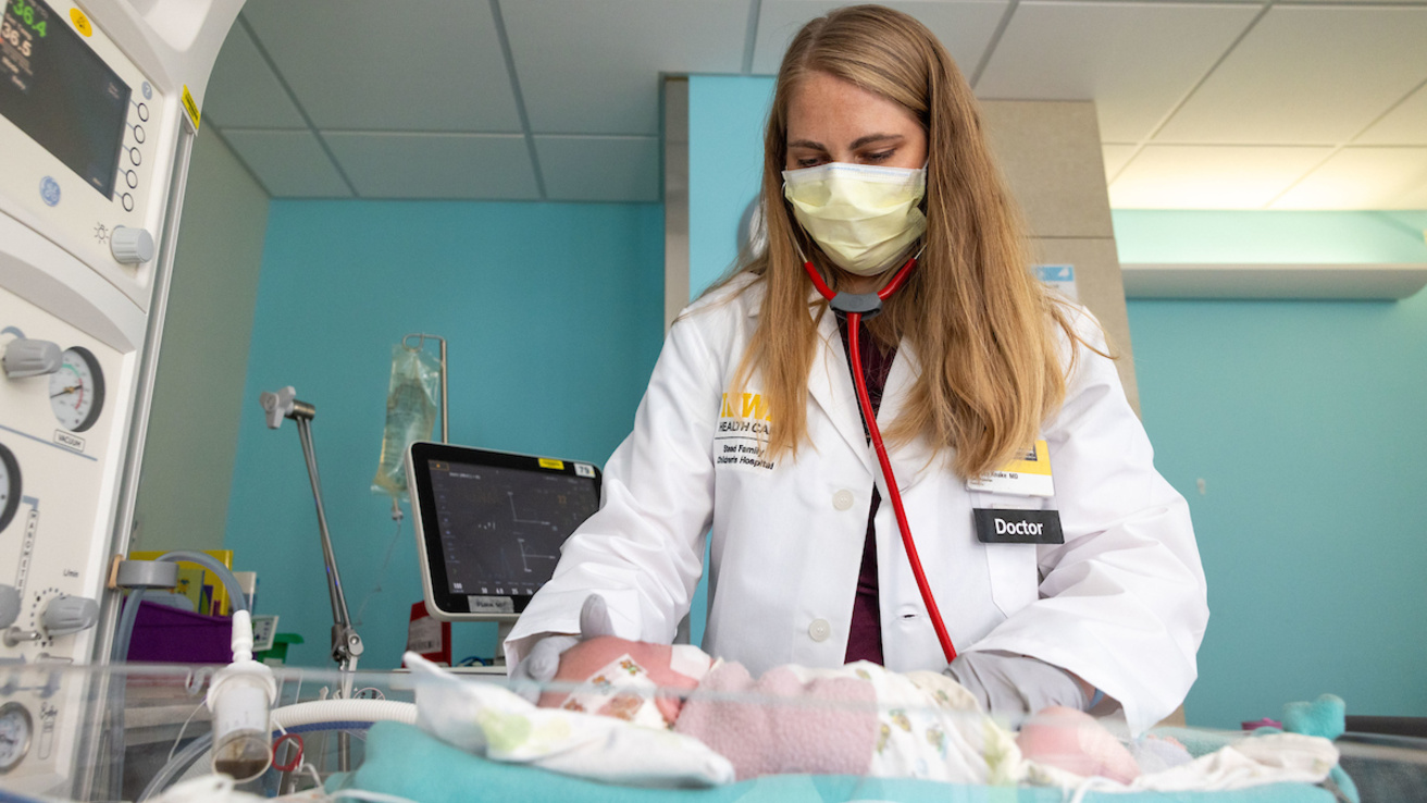 Neonatal specialist examining an inpatient baby. 